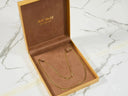 Timeless Strength 18K gold anchor chain in open velvet jewelry box