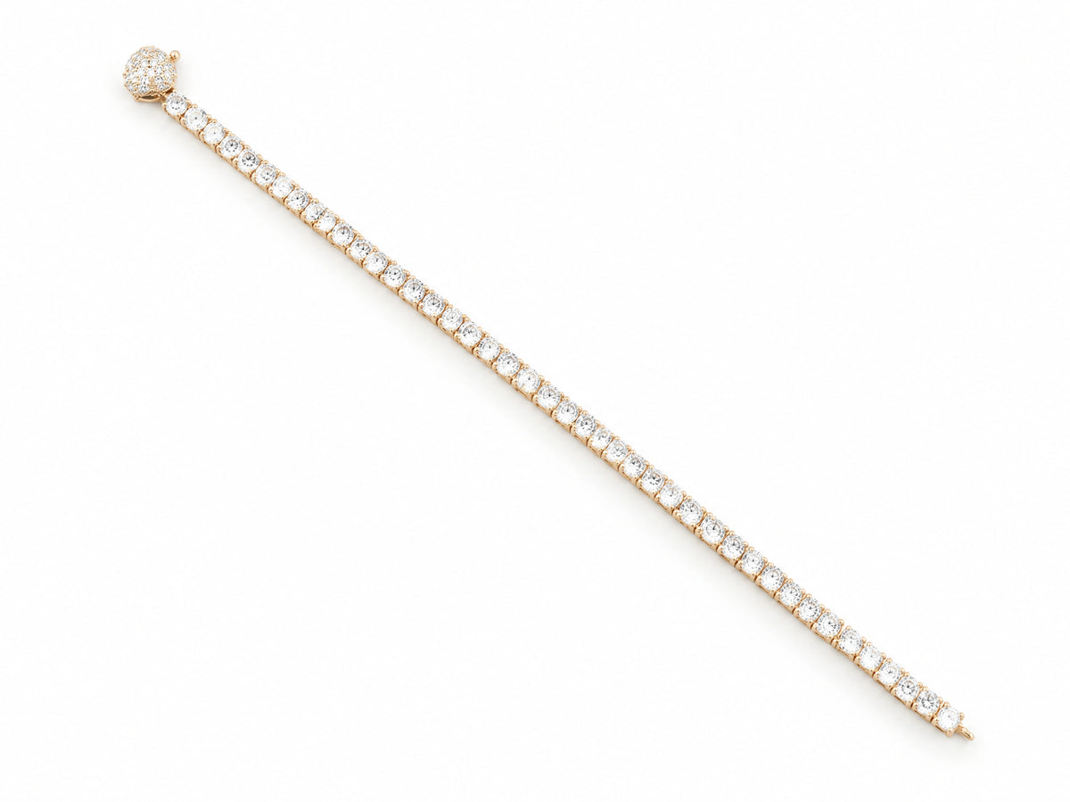 The bracelet opened and laid in an arc seen from above, the pave-set spherical clasp at one end and the plain gold loop it fastens to at the other