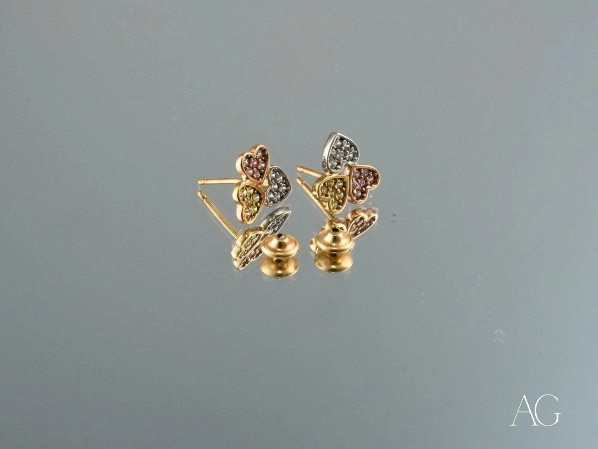 Trio Harmony 18k gold three-tone CZ stud earrings with heart gem clusters