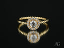 Twist of Grace engagement ring with twisted band in 18k gold halo diamonds