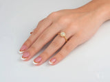 Twist of Grace engagement ring with 18k gold twisted band and sparkling diamond cluster