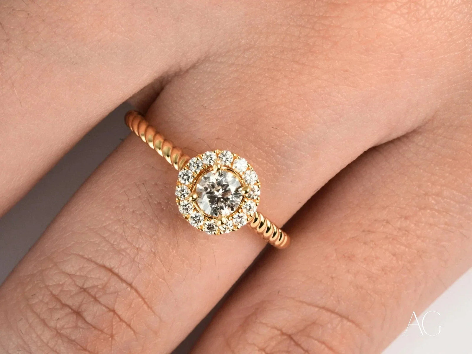 Twist of Grace engagement ring in 18k gold with twisted band and diamond halo