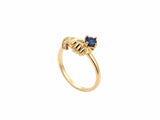 Side view of white gold ring with sculpted hands, diamond cuff and sapphire detail
