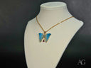 18k solid gold elegance pendant: blue butterfly with red gemstone