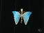 Gold butterfly pendant in 18k solid gold with blue banded agate wings and ruby gemstone