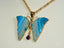 Elegant art gold jewelry pendant in 18k solid gold with blue agate wings and ruby gemstone