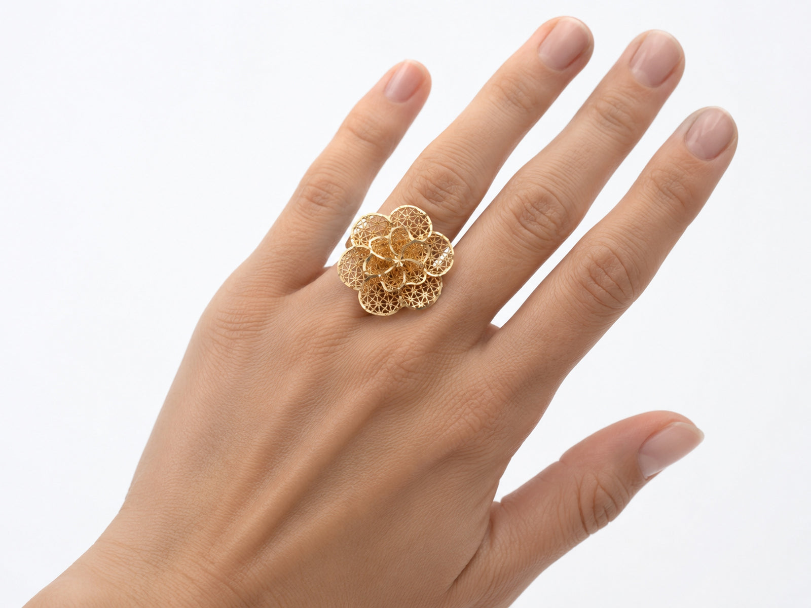 Close-up view of 18K gold flower ring featuring intricate openwork lattice petal design