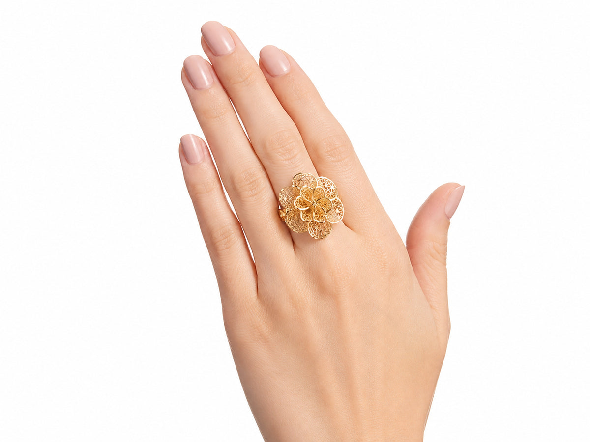 Overhead view of 18K gold flower ring displaying layered openwork petals with geometric lattice detail