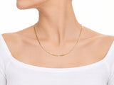 14K yellow gold Cuban chain worn at the neck, the jawline at the top of the frame