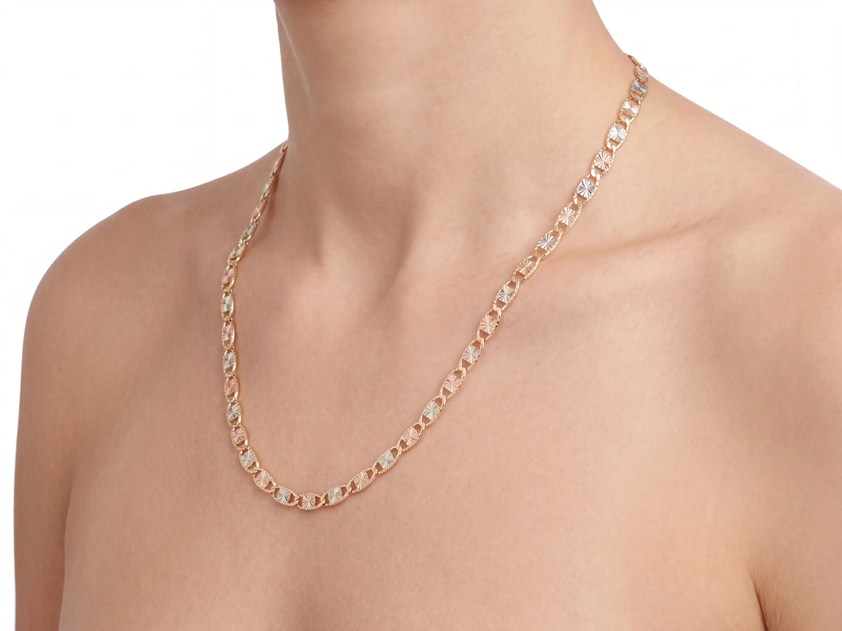 14K tri-colour piastrine chain on a display bust, rose and white plates draping to the upper chest