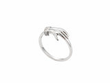 Side view of yellow gold ring with sculpted clasped hands, sapphire and diamond accents